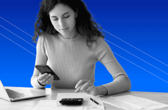 young woman at desk using a personal loan calculator