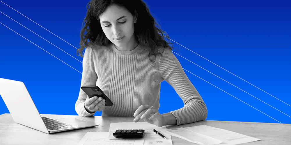 young woman at desk using a personal loan calculator