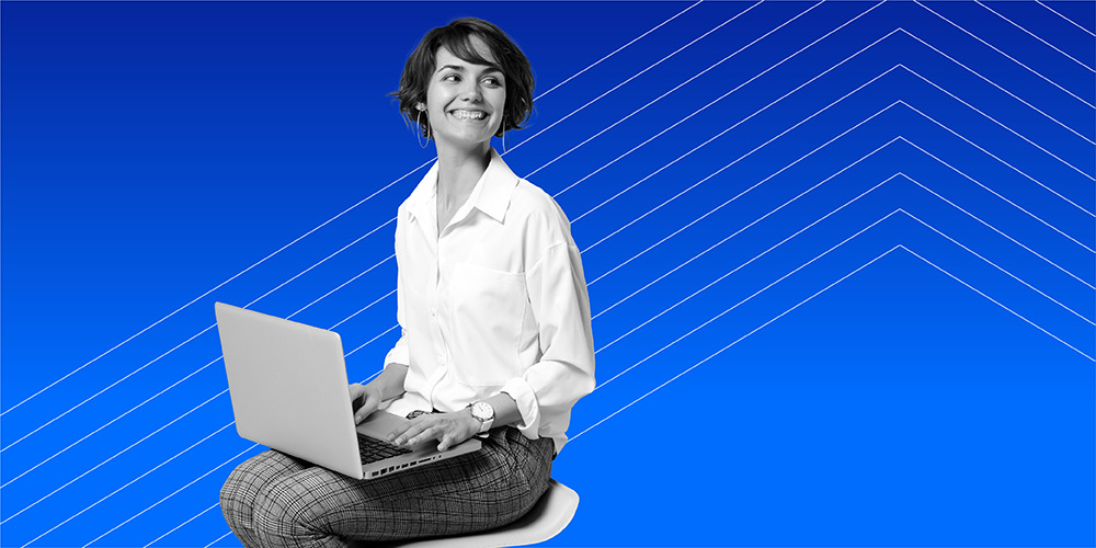 woman smiling while working on computer