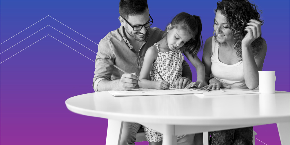 mother and father teaching financial literacy to their daughter at a table