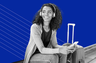 young woman wearing headphones with suitcase