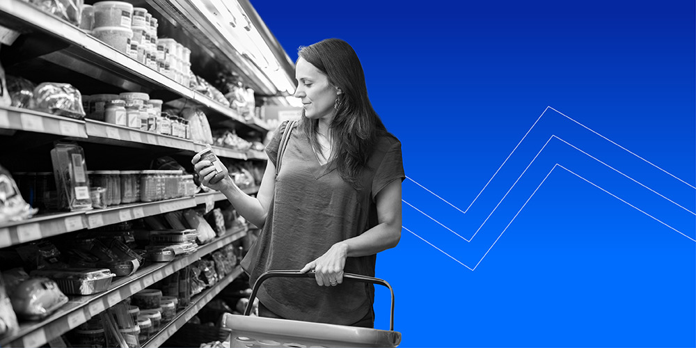 woman holding shopping basket and looking at groceries