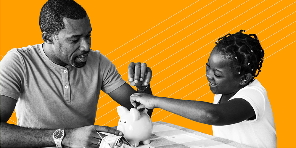 man and daughter putting coins in a piggy bank