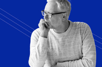 older man with glasses with his hand on his chin