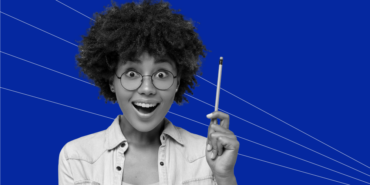young woman with glasses and curly hair holding a pencil and acting excited after realizing eating healthy doesn’t have to break the bank