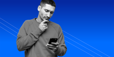 young man looking at his phone and wondering can you get a no-interest cash advance loan?