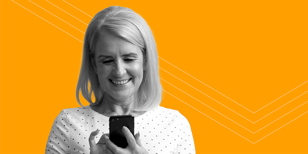 woman with blond hair looking at the top 5 free personal finance apps on her phone