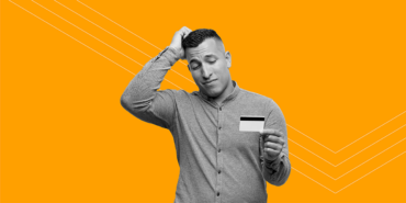 man scratching his head and holding a credit card wondering can you pay off a personal loan with a credit card?
