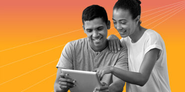 young couple working on financial literacy crossword puzzles on an iPad